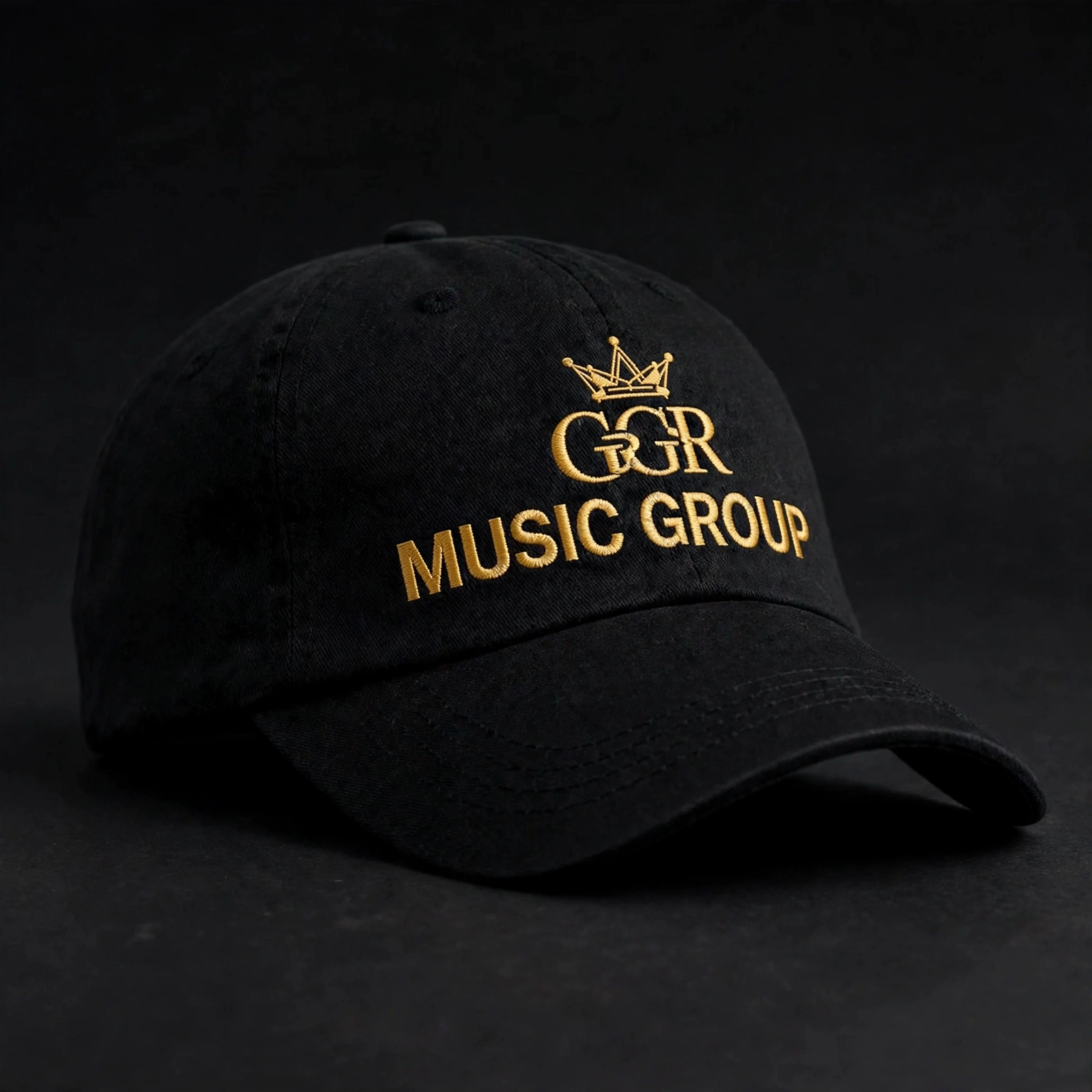 Pristine all-black cap embroidered in gold with the streamlined GGR crown and Music Group lettering