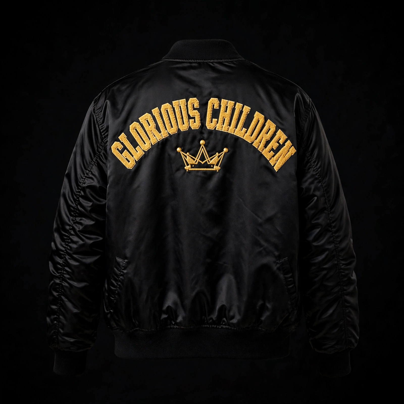 Black satin bomber jacket embroidered Glorious Children and a gold crown on the back